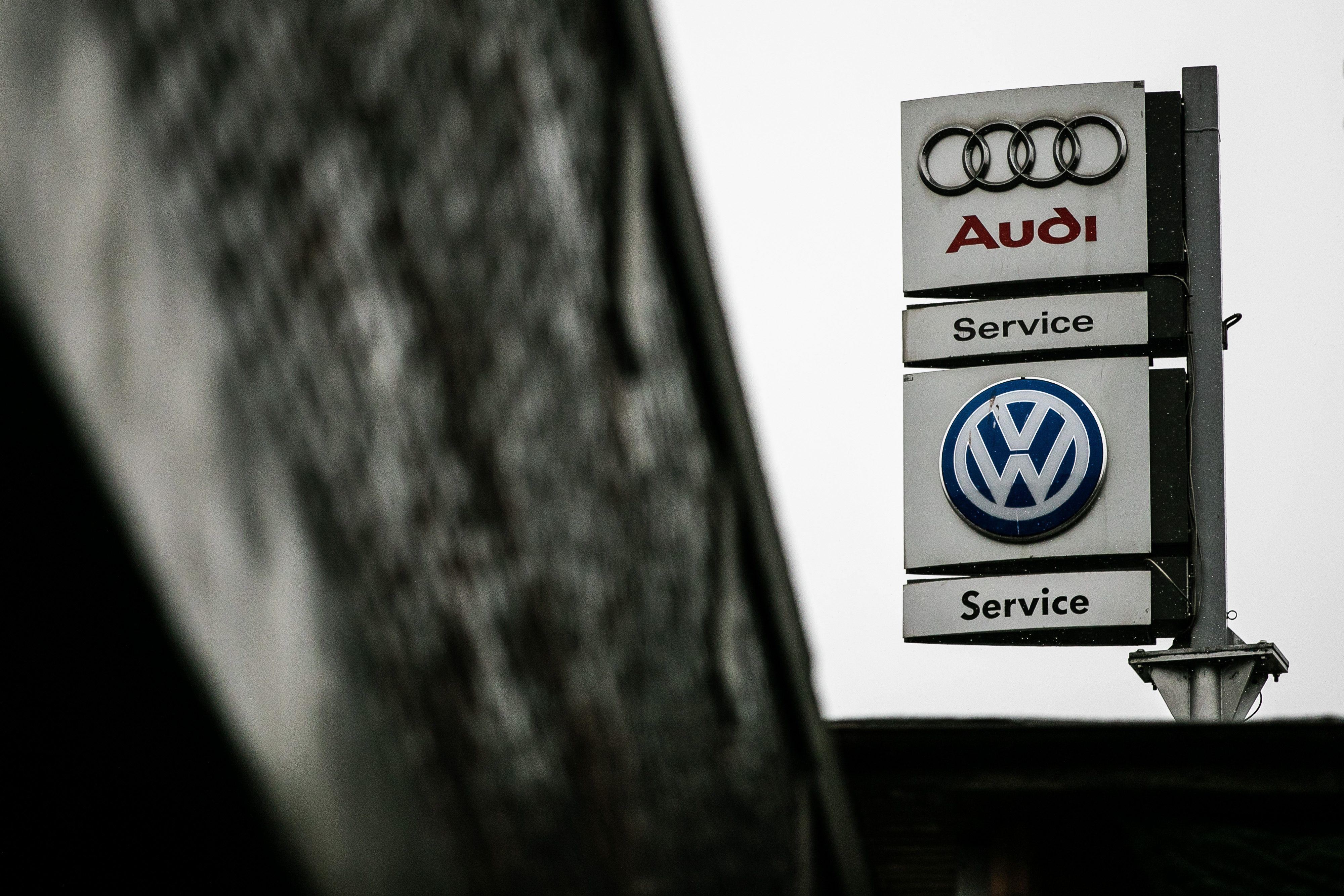 A sign showing Audi and VW dealerships
