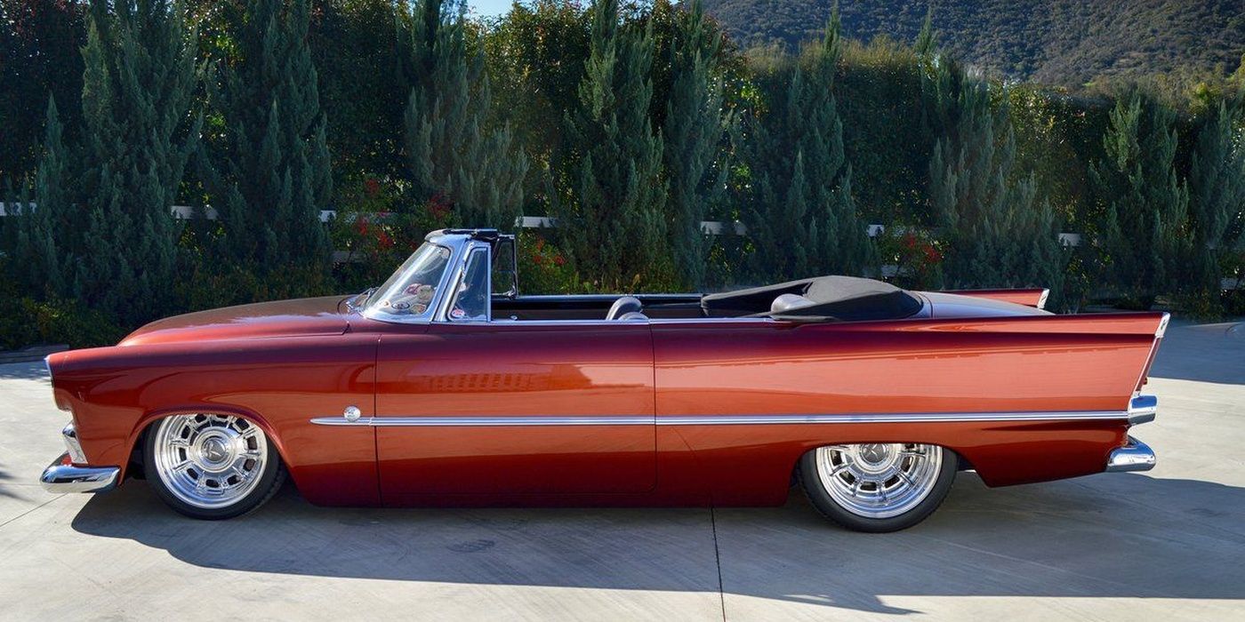 A 1956 Plymouth Belvedere convertible from the left side, in red