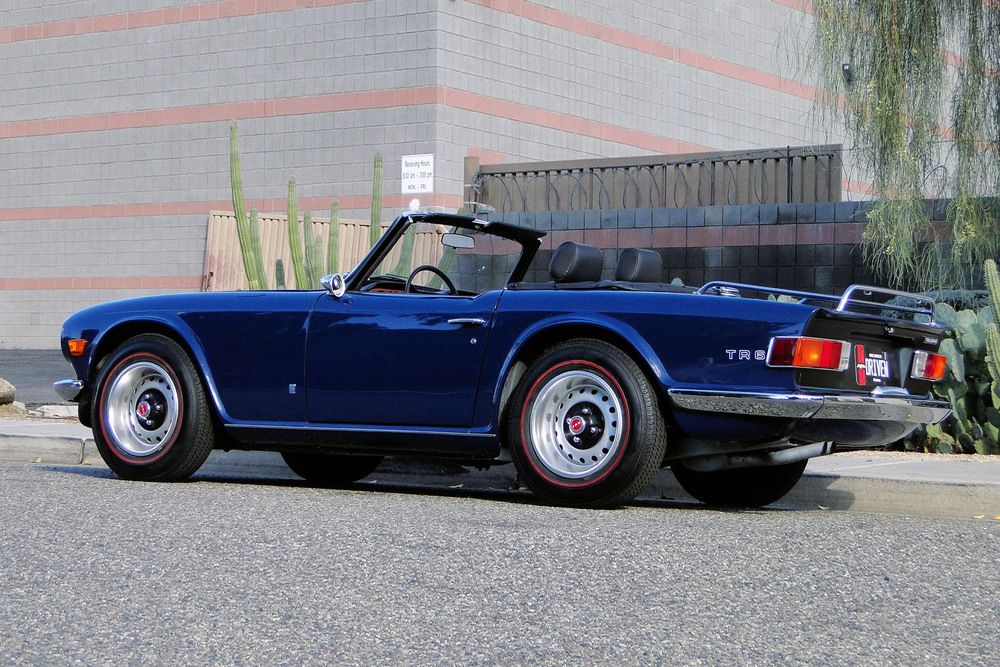 Navy blue TR6 parked with its roof down
