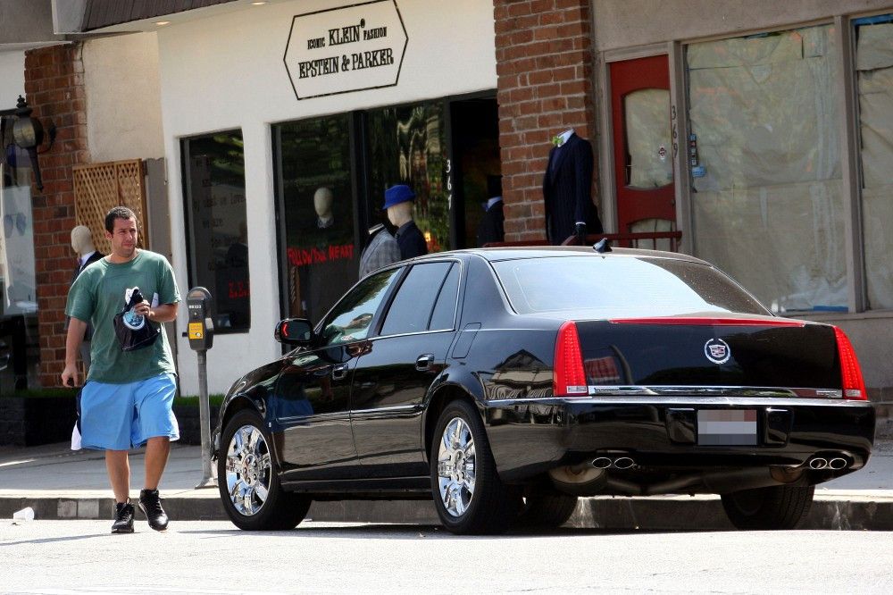 A rare Adam Sandler alone, having stepped out of his Cadillac DTS