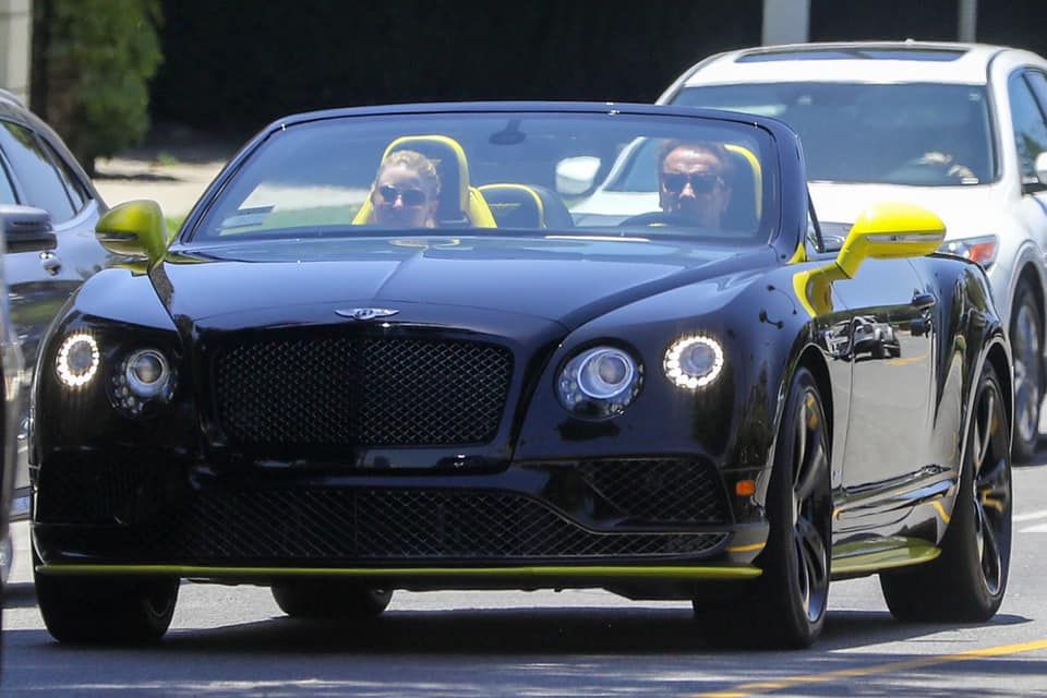 Arnold Schwarzenegger cruzing around in his Bentley Continental GT Speed with the top down.