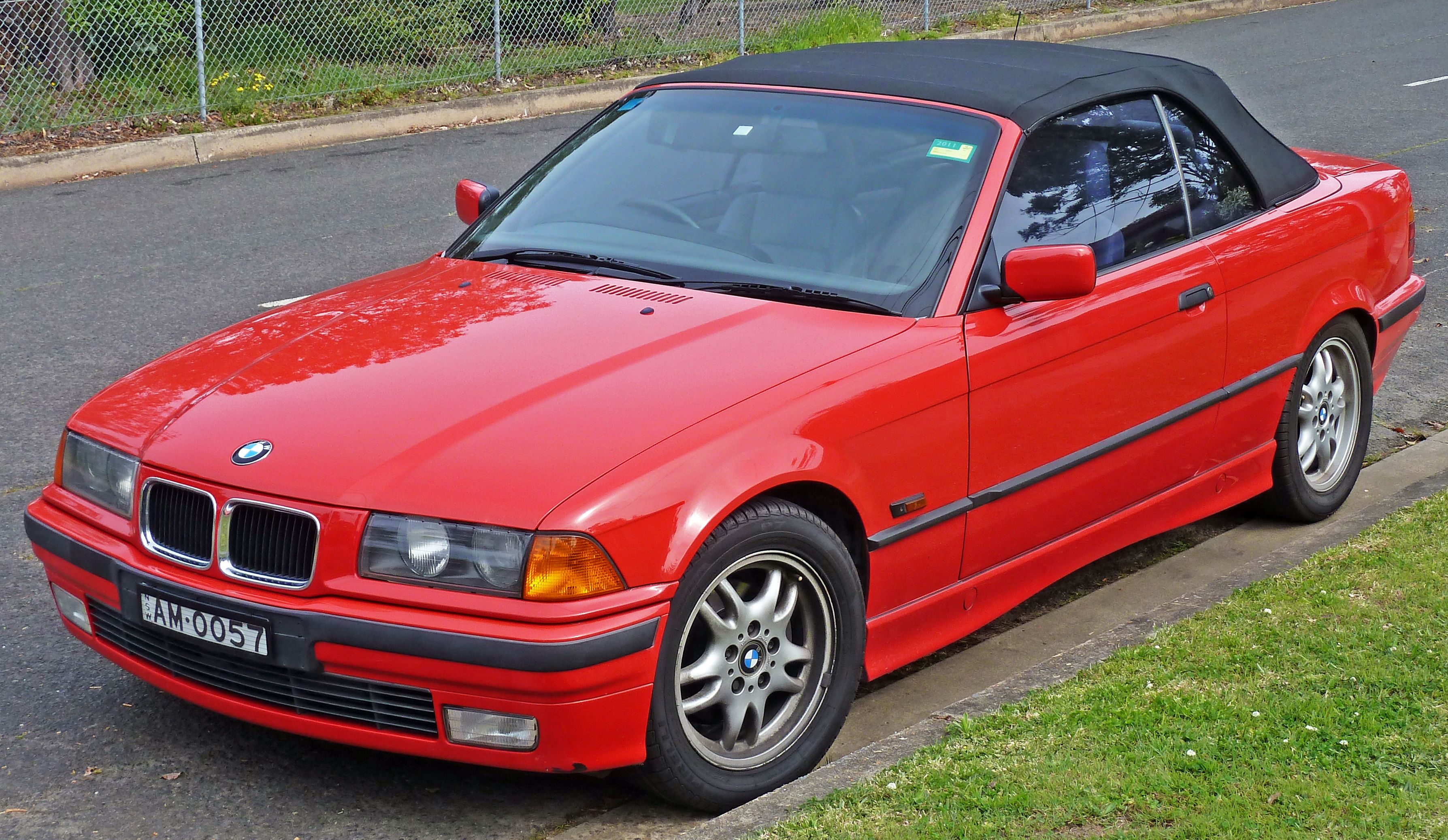 red BMW 3-Series (E36) on the road