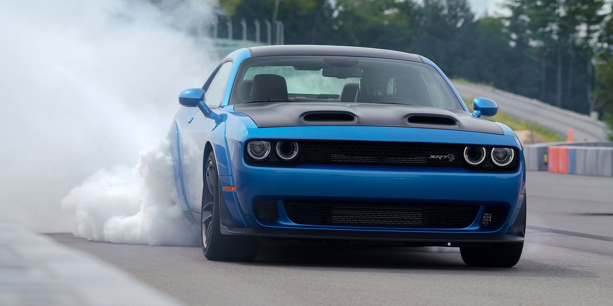 A blue Hellcat Widebody doing a burnout