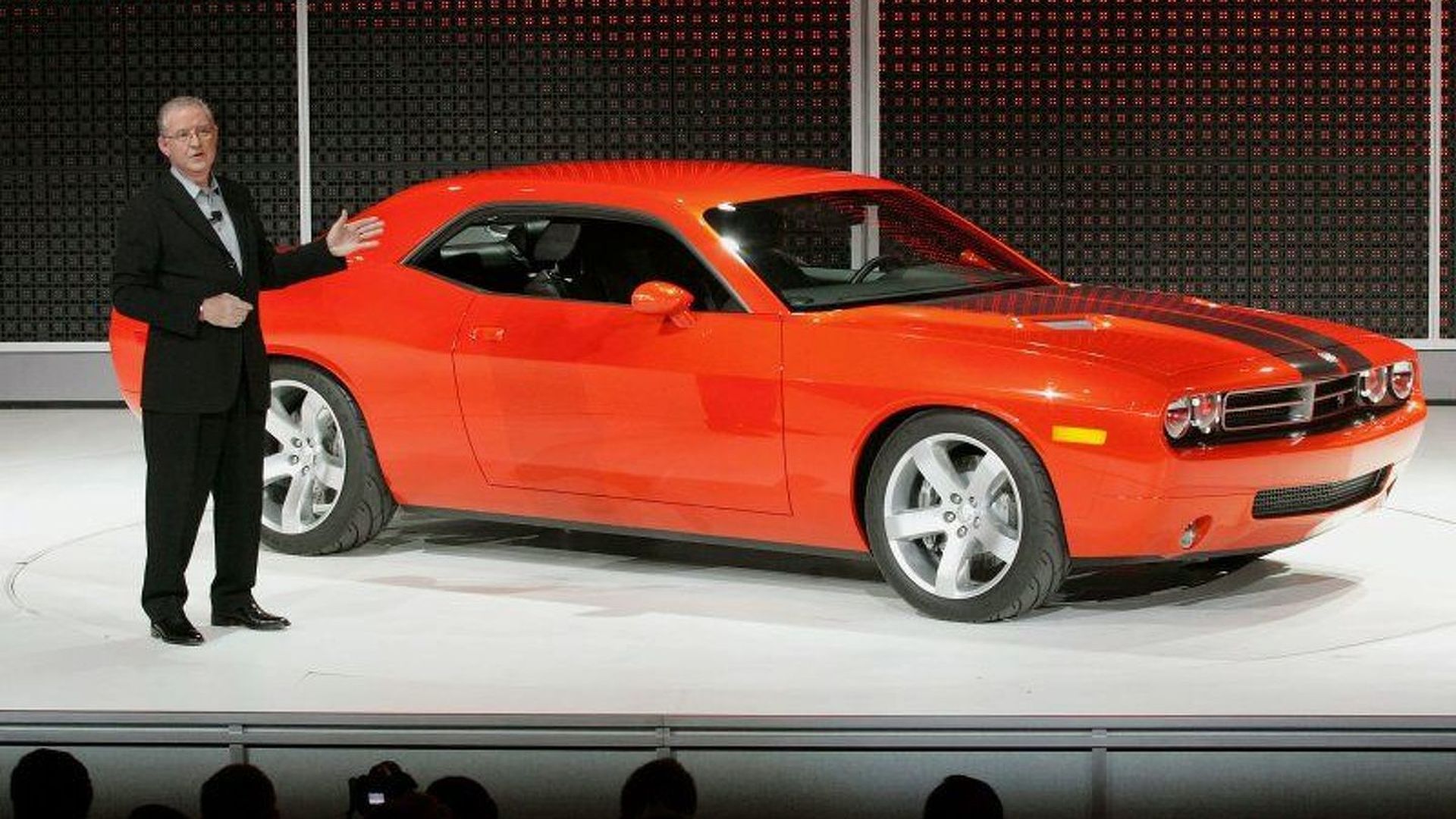 a man showing the 2006 dodge challenger