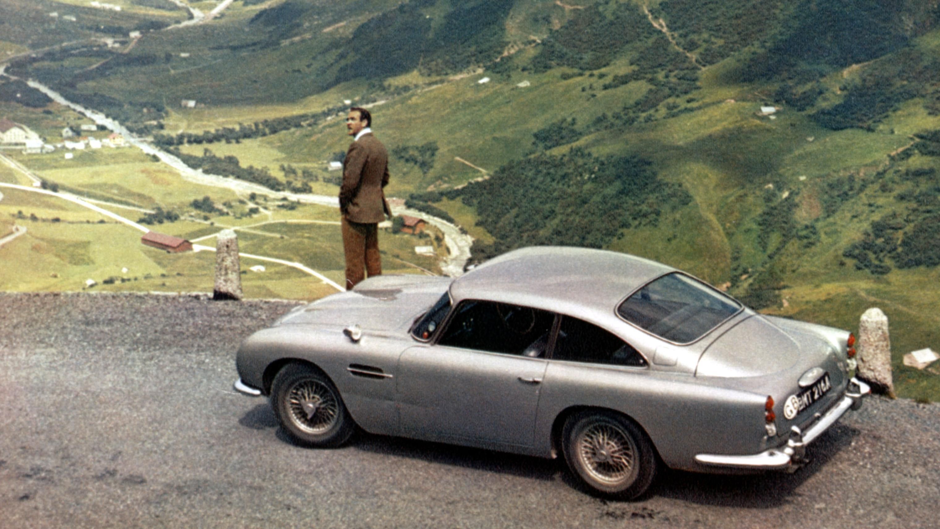 Sean Connery stops his Aston Martin in the mountains