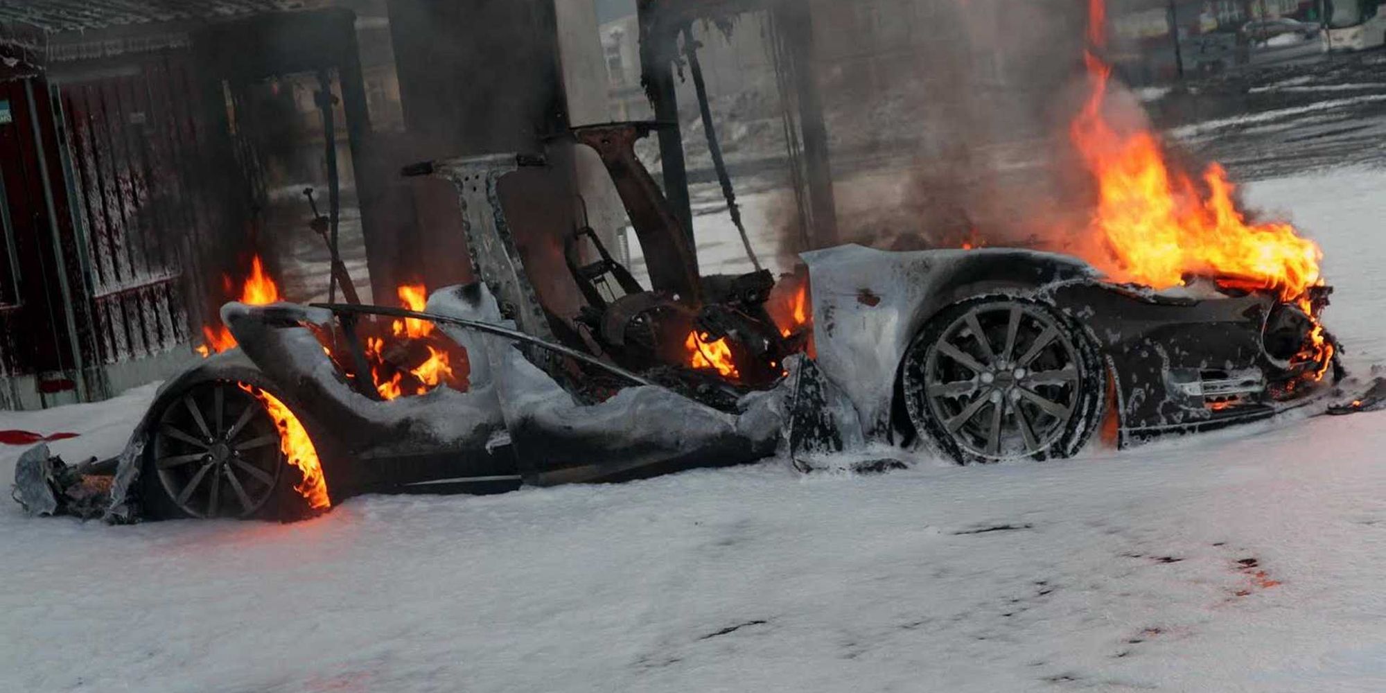 A burned out Tesla Model S, still on fire