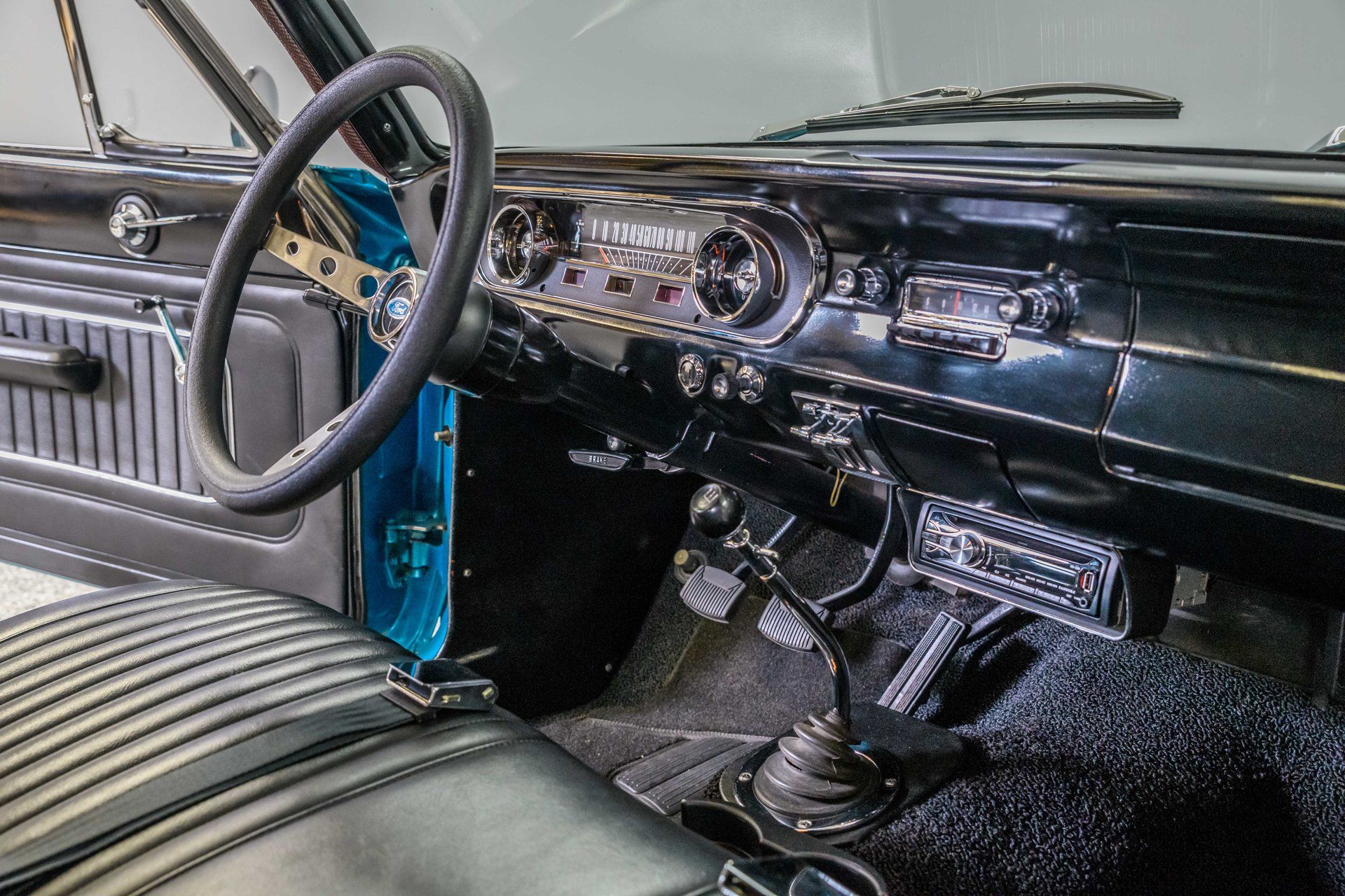 The 1965 Ford Falcon Futura interior, with an open door