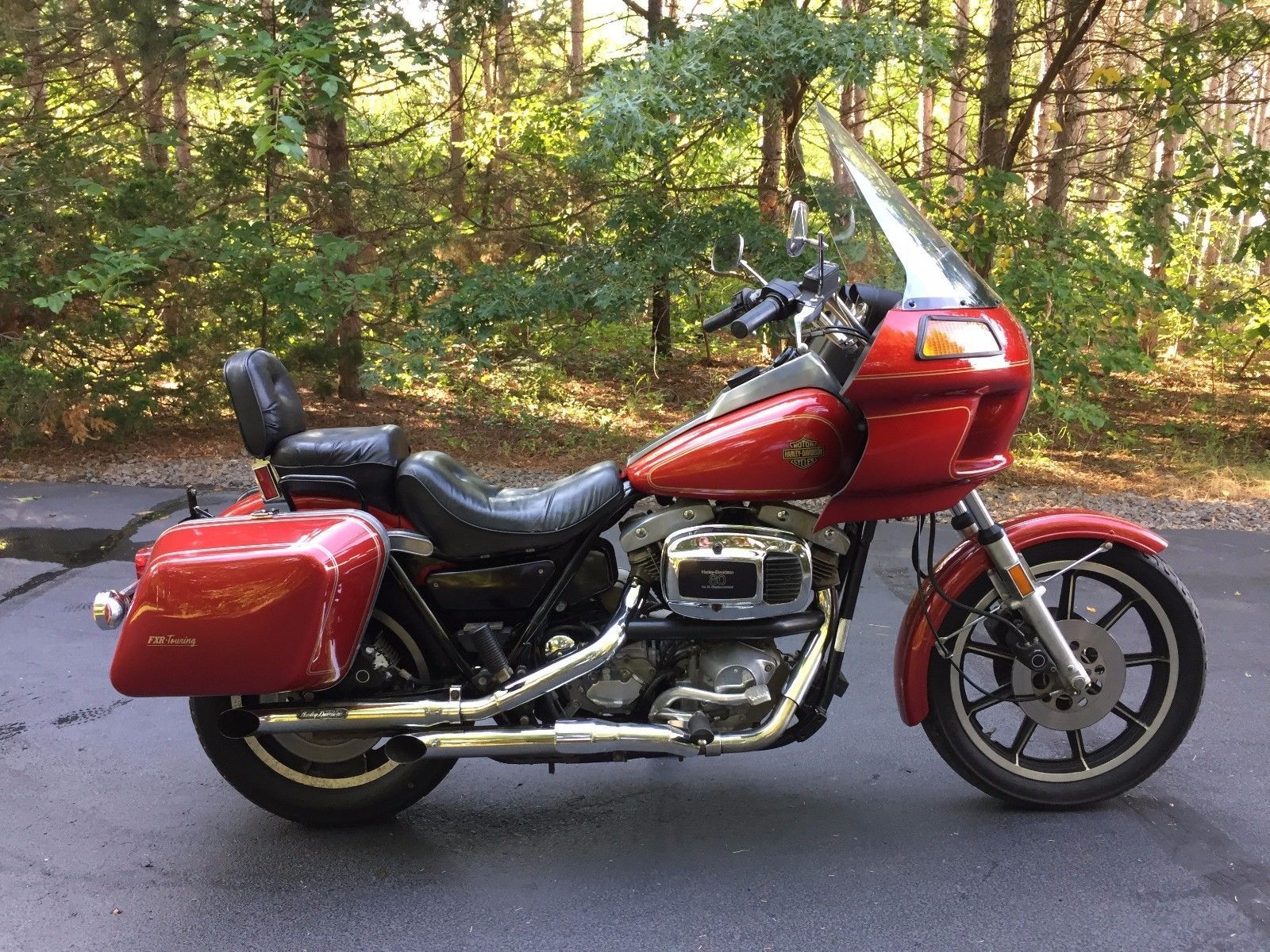 a red 1983 Harley-Davidson FXRT parked outside