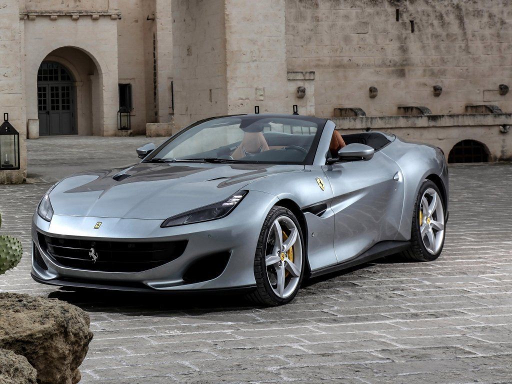 Silver Ferrari Portofino parked on a street in Italy