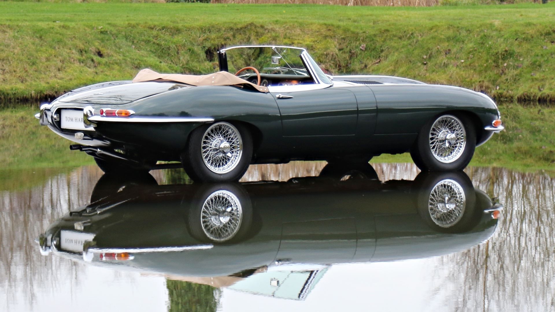 Jaguar E-Type parked on top of a lake
