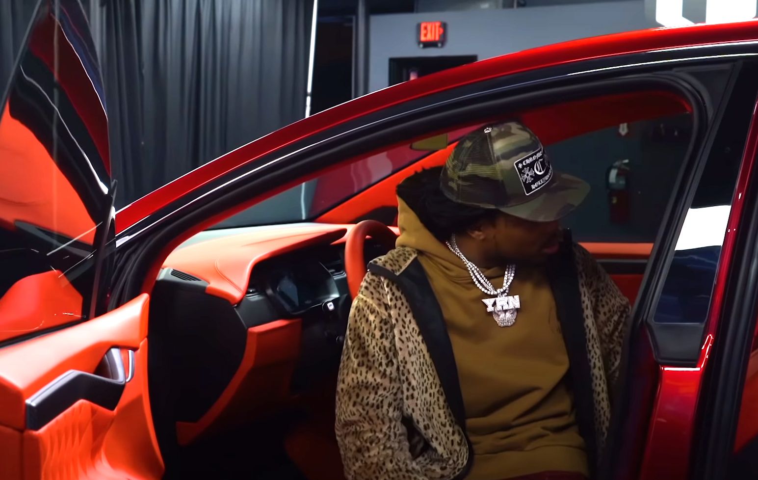 Quavo Huncho inspects the design work on his modded Tesla X
