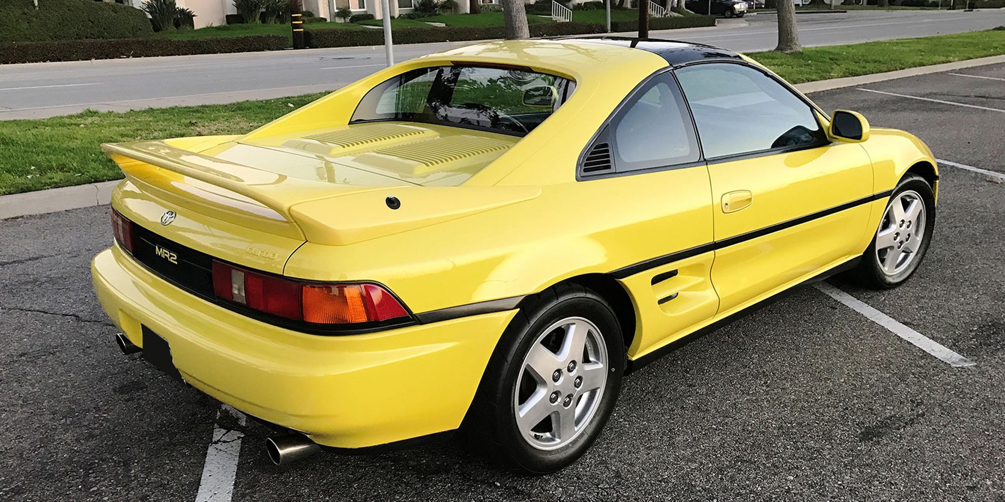 Rear 3/4 view of a yellow MR2 Turbo
