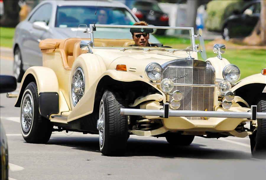 arnold schwarzenegger driving one of his vintage cars