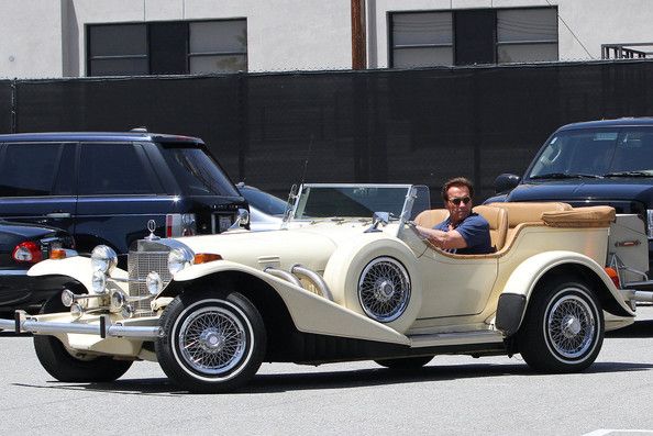 arnold schwarzenegger driving one of his vintage cars