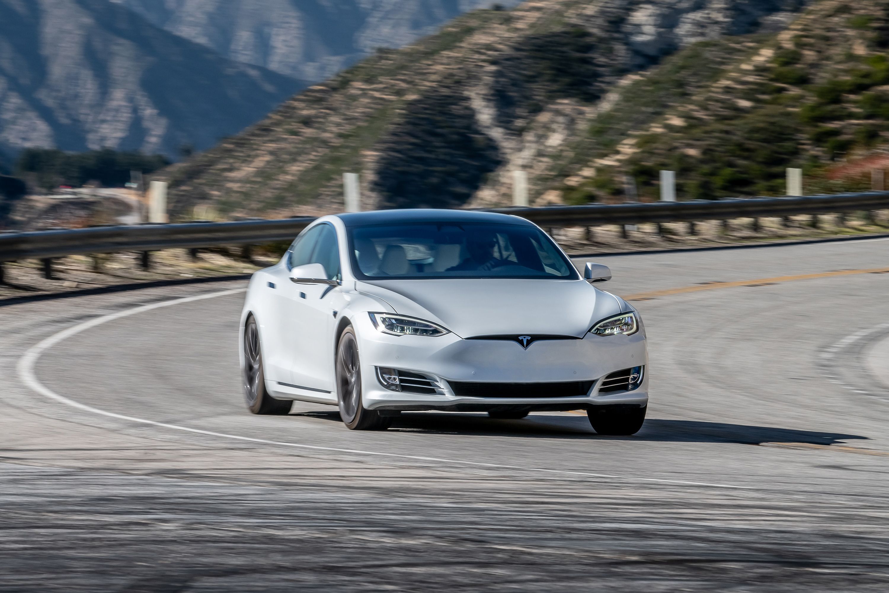 2021 Tesla Model X rounding the curve