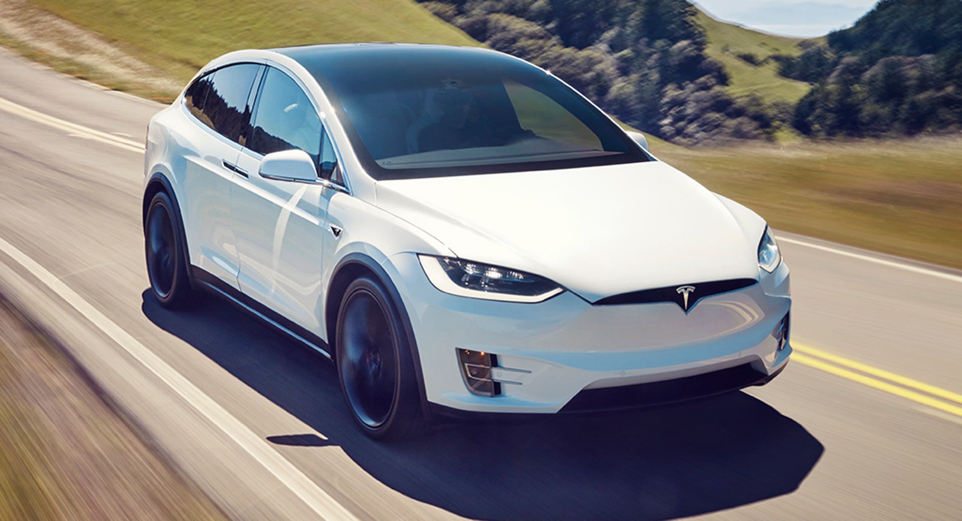 White 2021 Tesla Model X driving down road