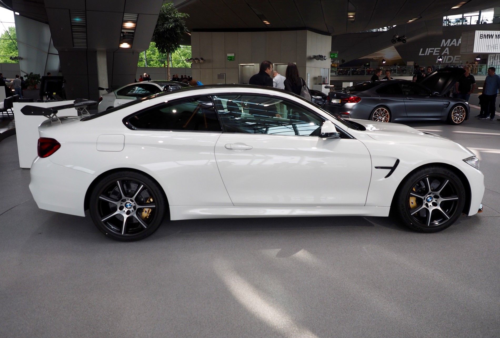 a white BMW M4 GTS with carbon fiber wheels