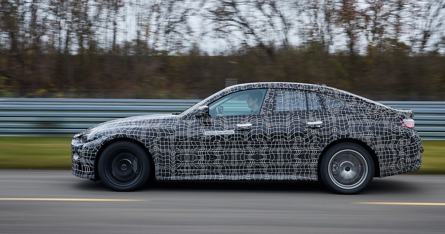 camouflaged BMW i4 prototype calibration runs side view