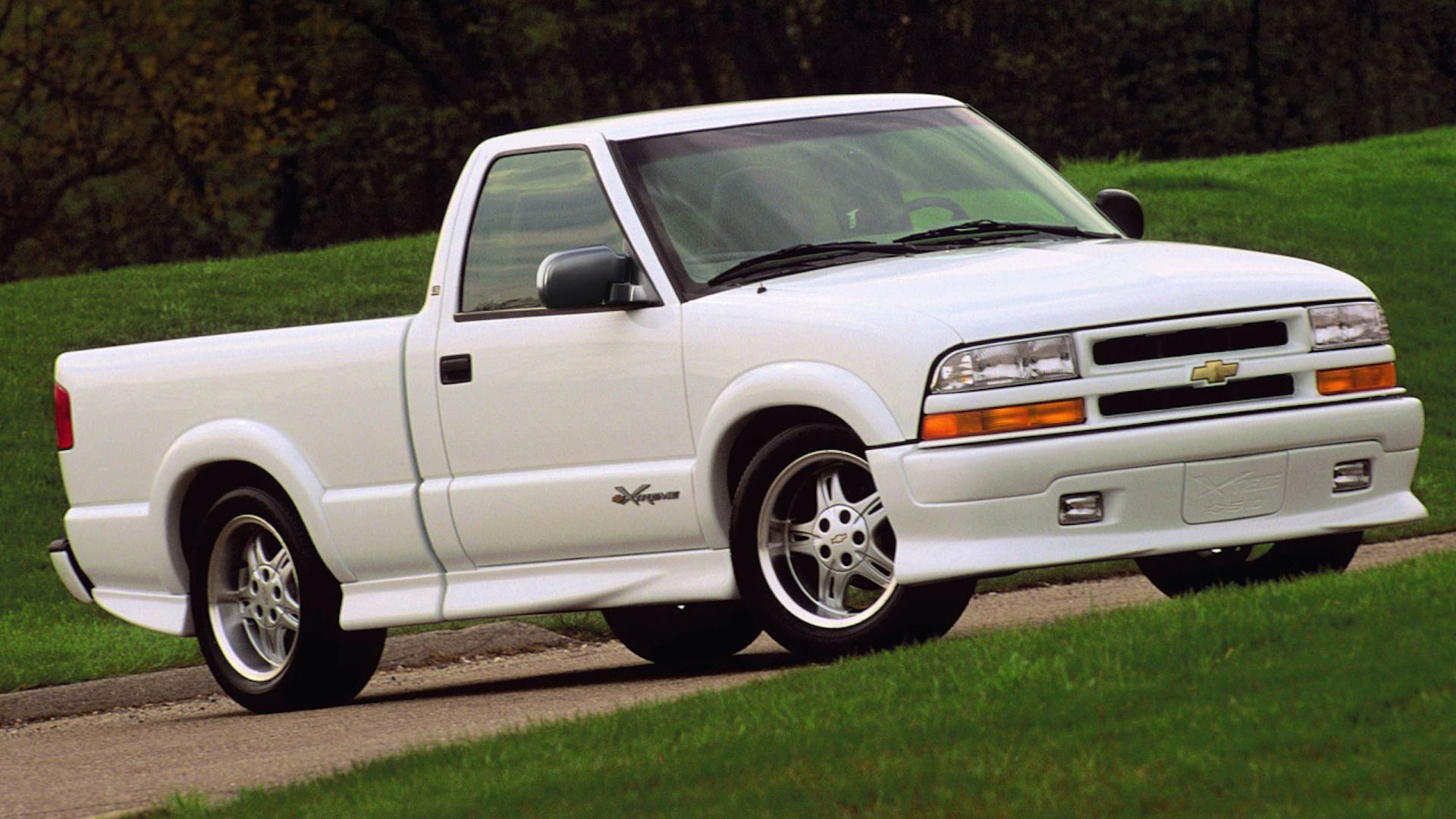A white Chevy S10 Extreme truck stands parked on a road.