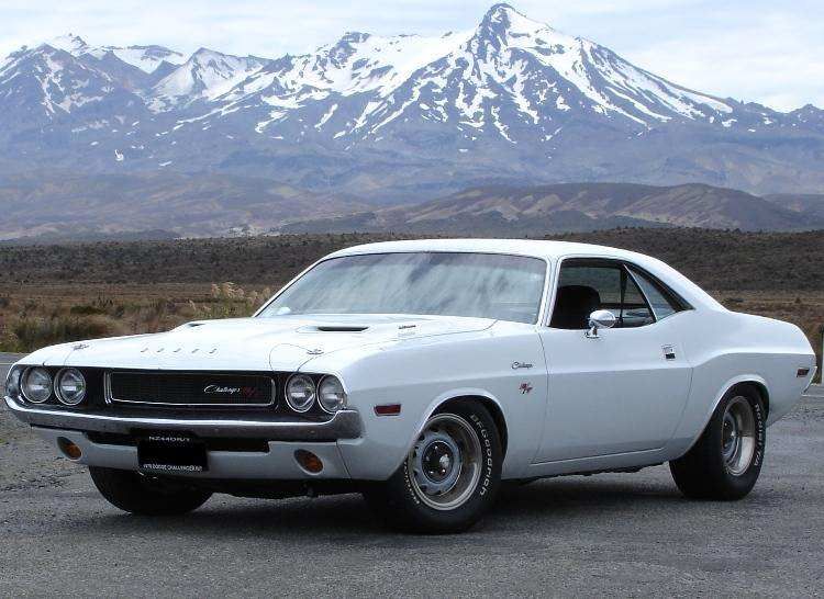 Vanishing Point Dodge Challenger parked in front of a mountain