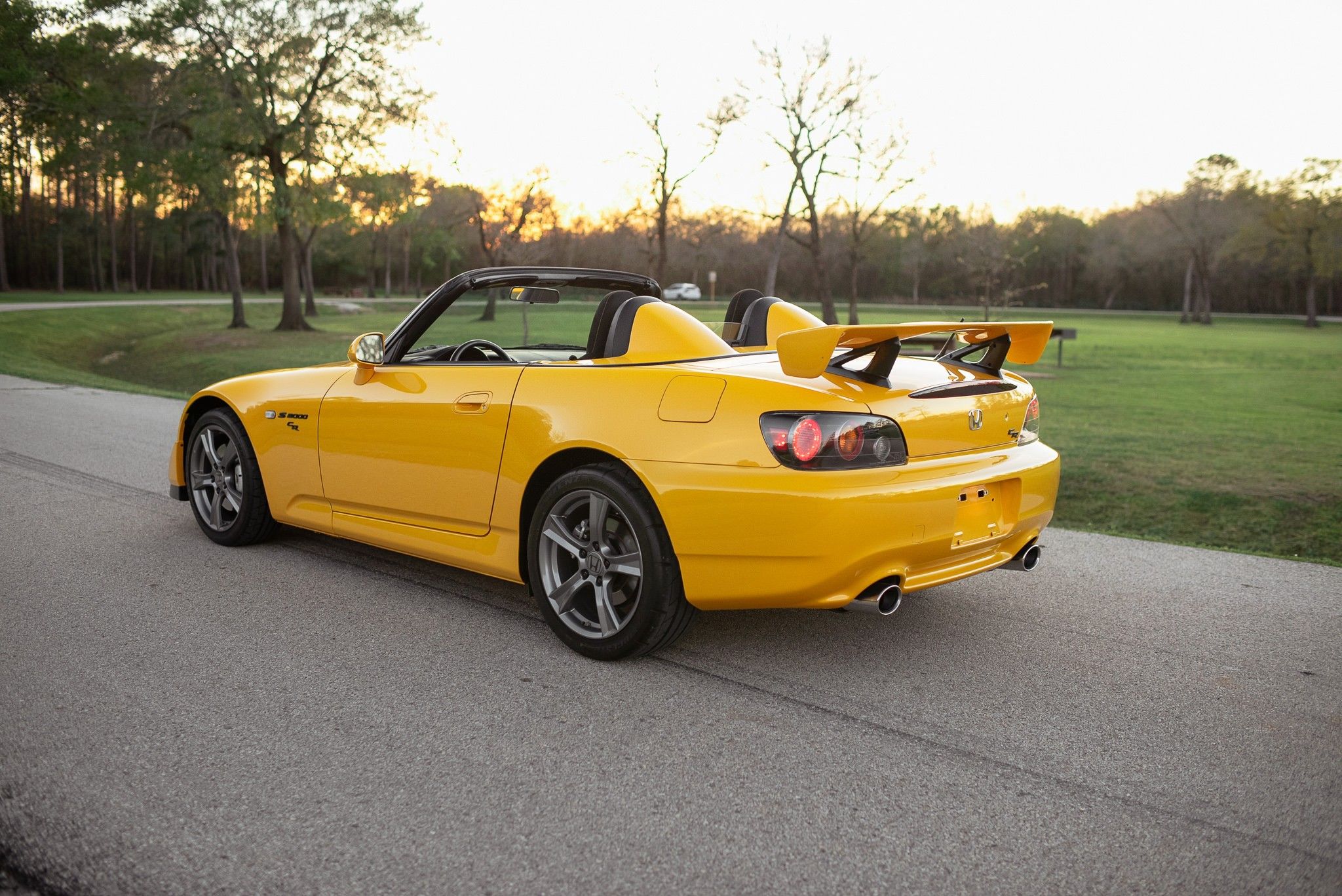 yellow Honda S2000 parked on the road