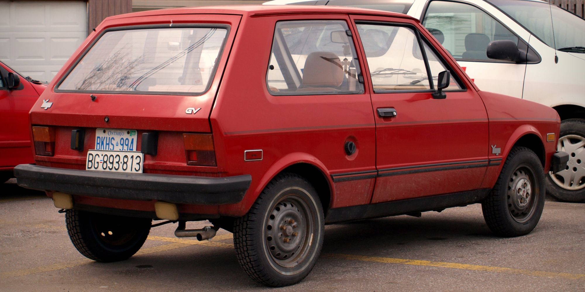 Rear 3/4 view of a red Yugo