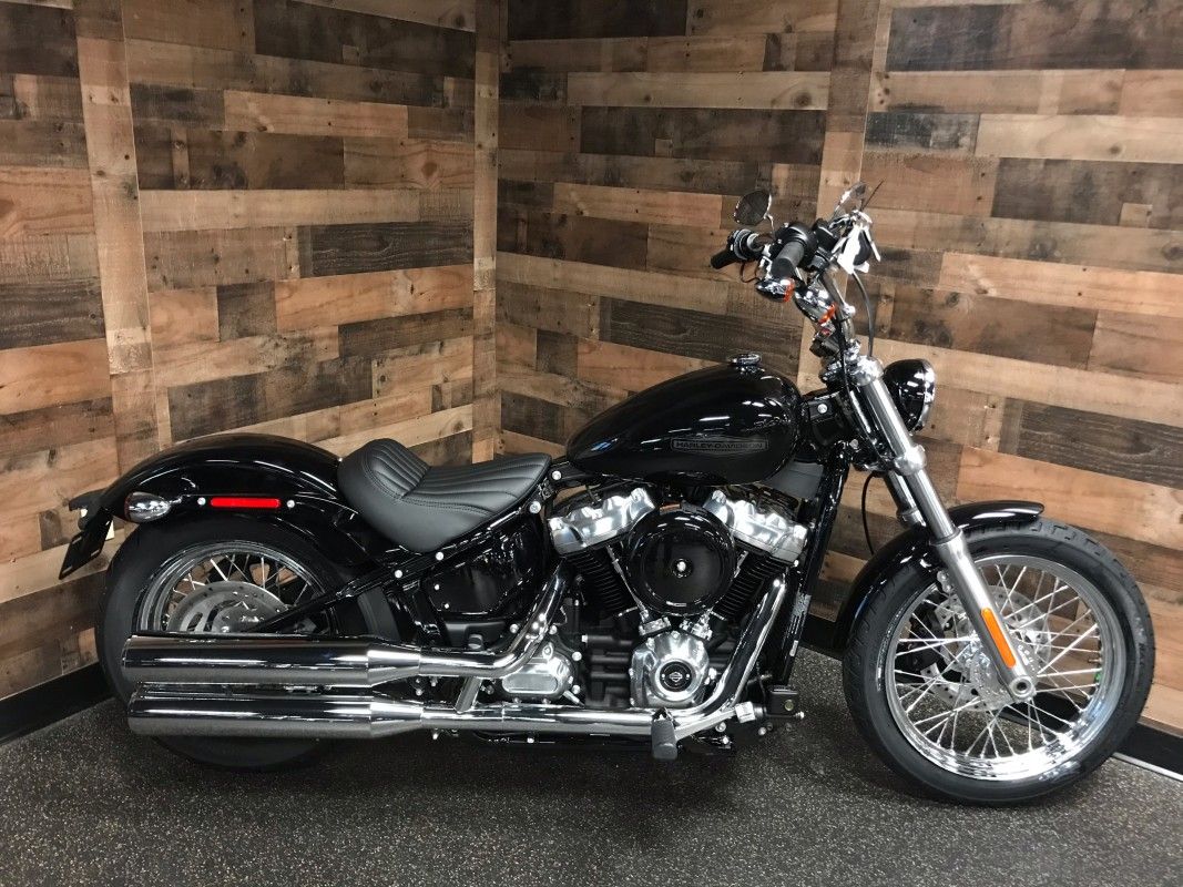 Black 2021 Harley-Davidson Softail Standard in front of wooden wall