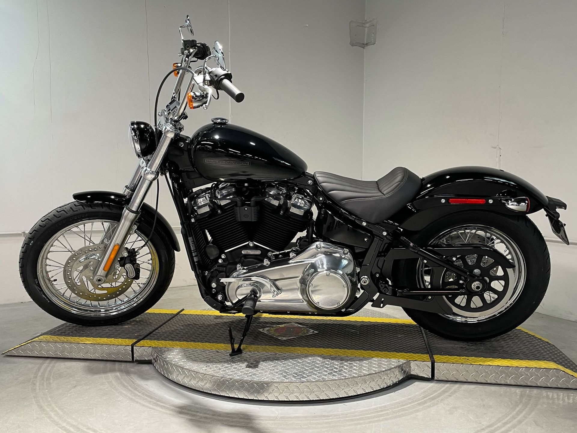 Black 2021 Harley-Davidson Softail Standard in showroom; side view