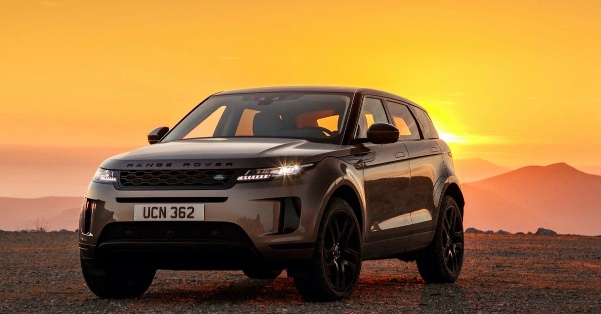 A brown 2021 Range Rover Evoque stands parked on a mountain summit.