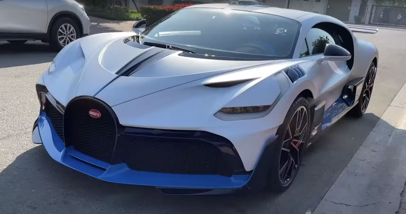 Blue and white Bugatti Divo parked on city street