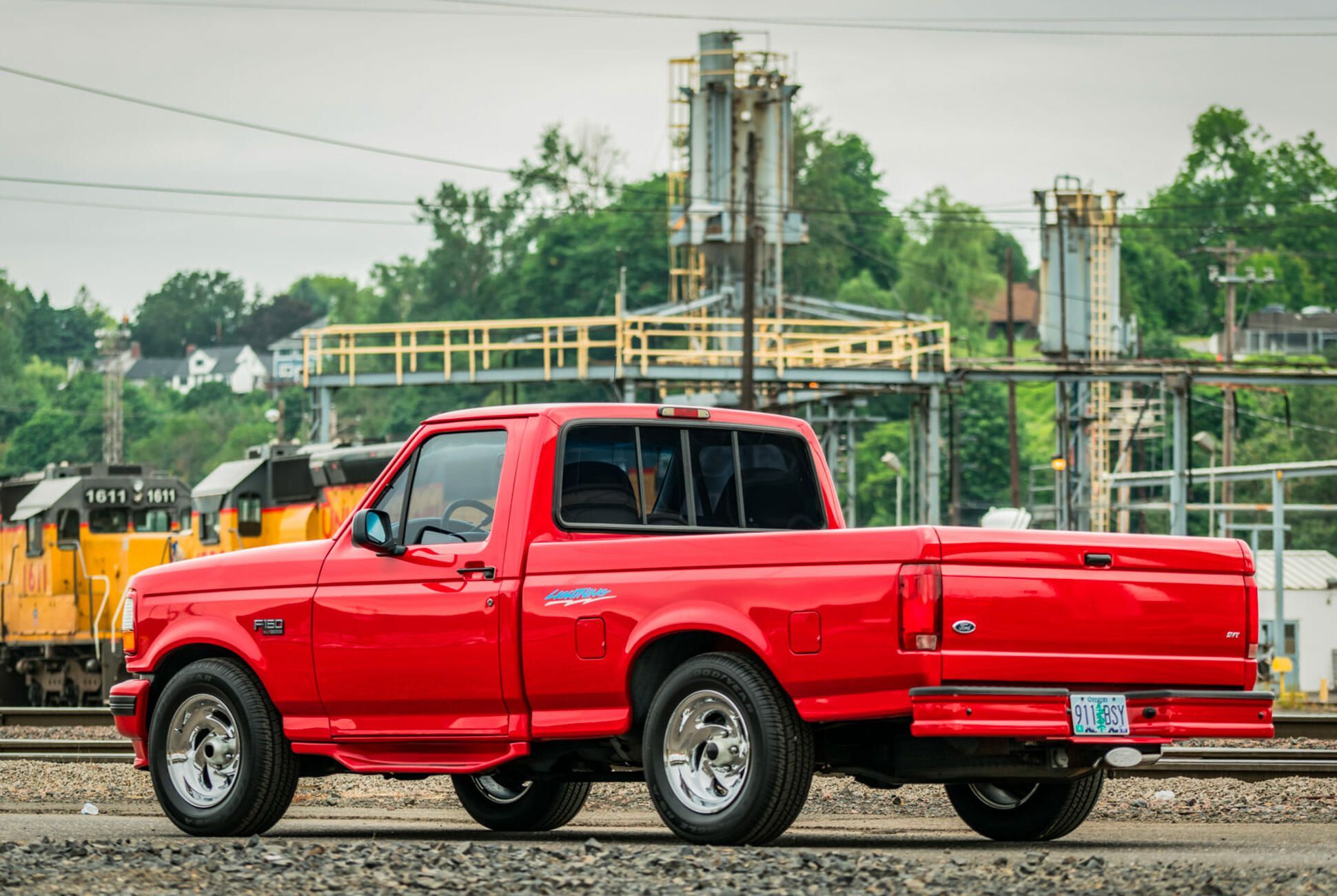 Red Ford F-150 Lightning outdoors; rear view