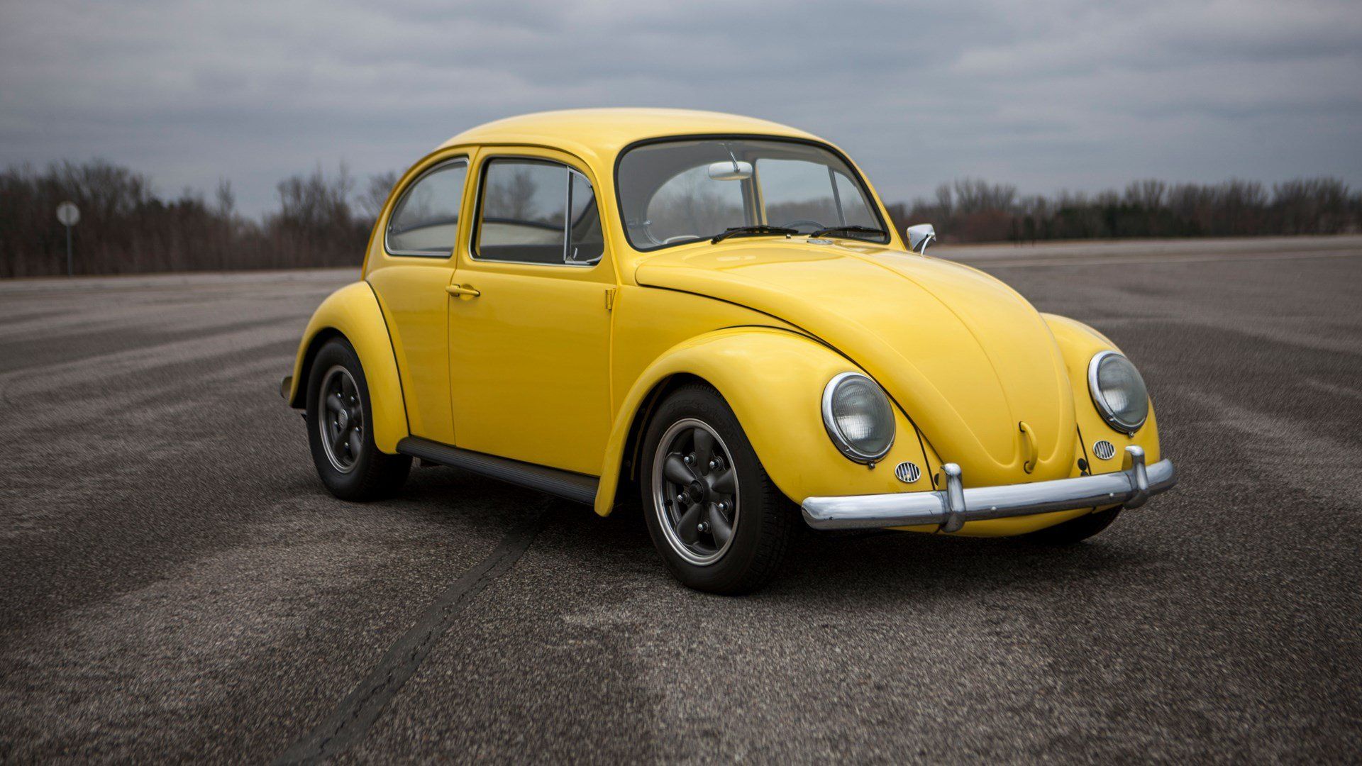 Yellow VW Beetle parked on asphalt