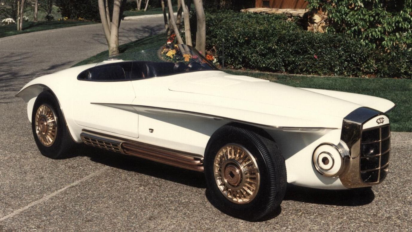 A 1965 Mercer Cobra Roadster stands parked on a road.