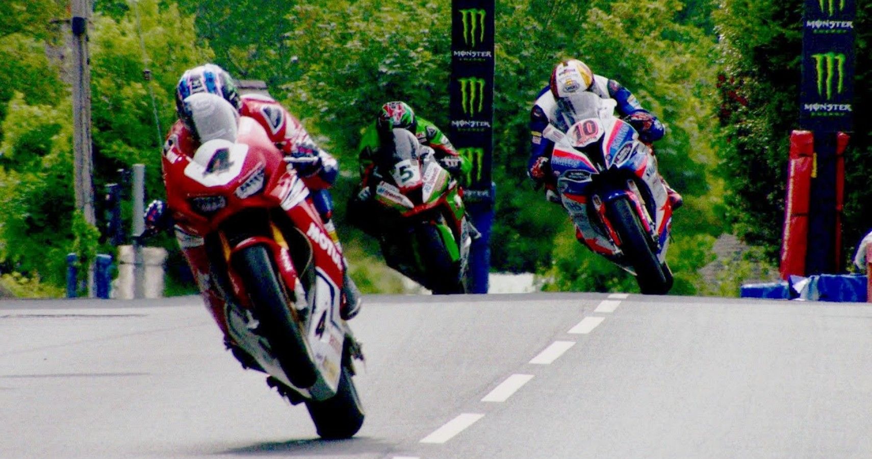 Three riders racing in the Isle of Man TT.