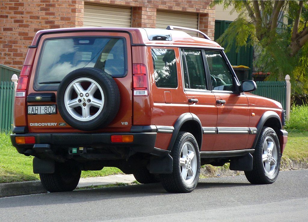 A red Land Rover Discovery Series II.