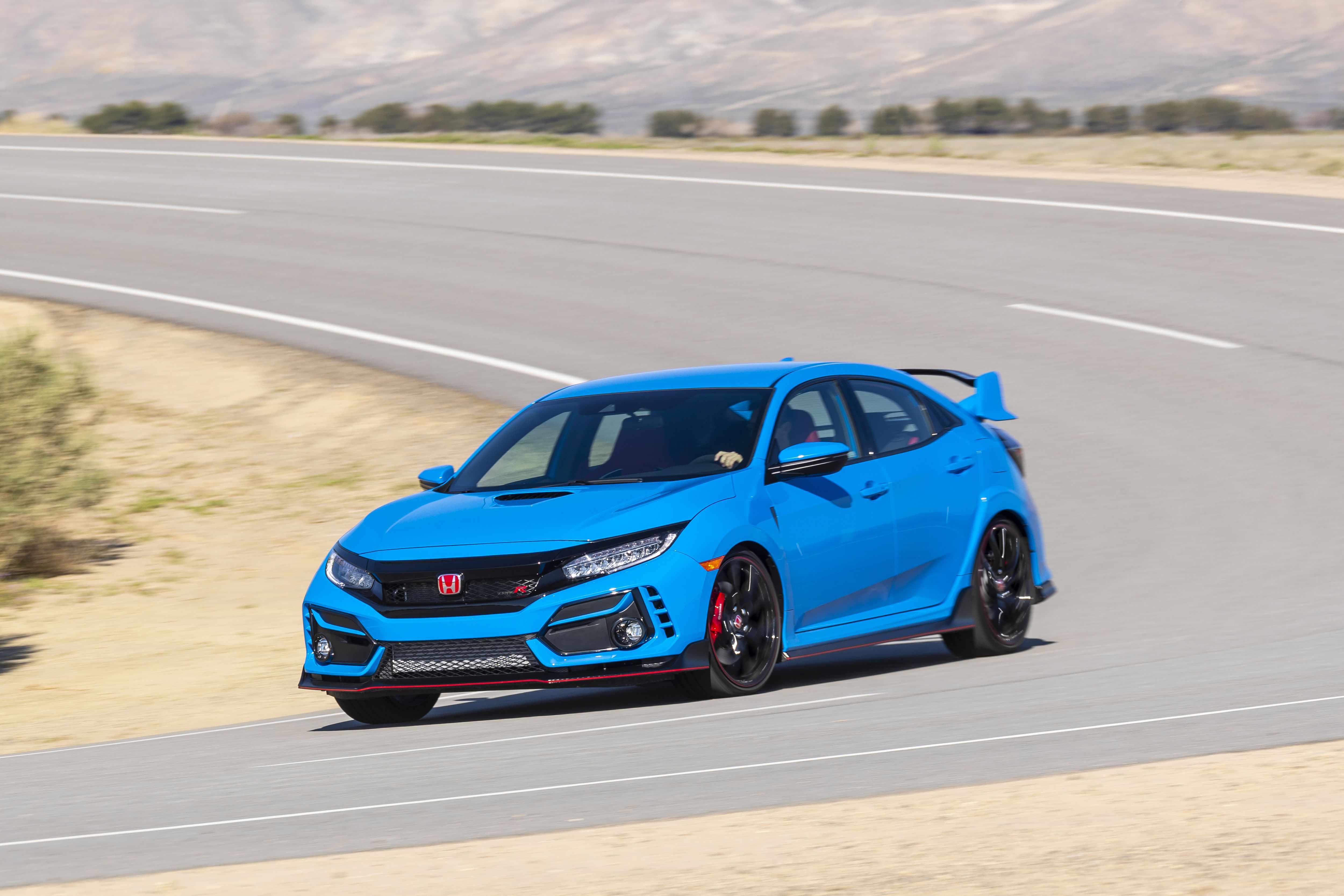 A blue Civic Type R on a twisty road.