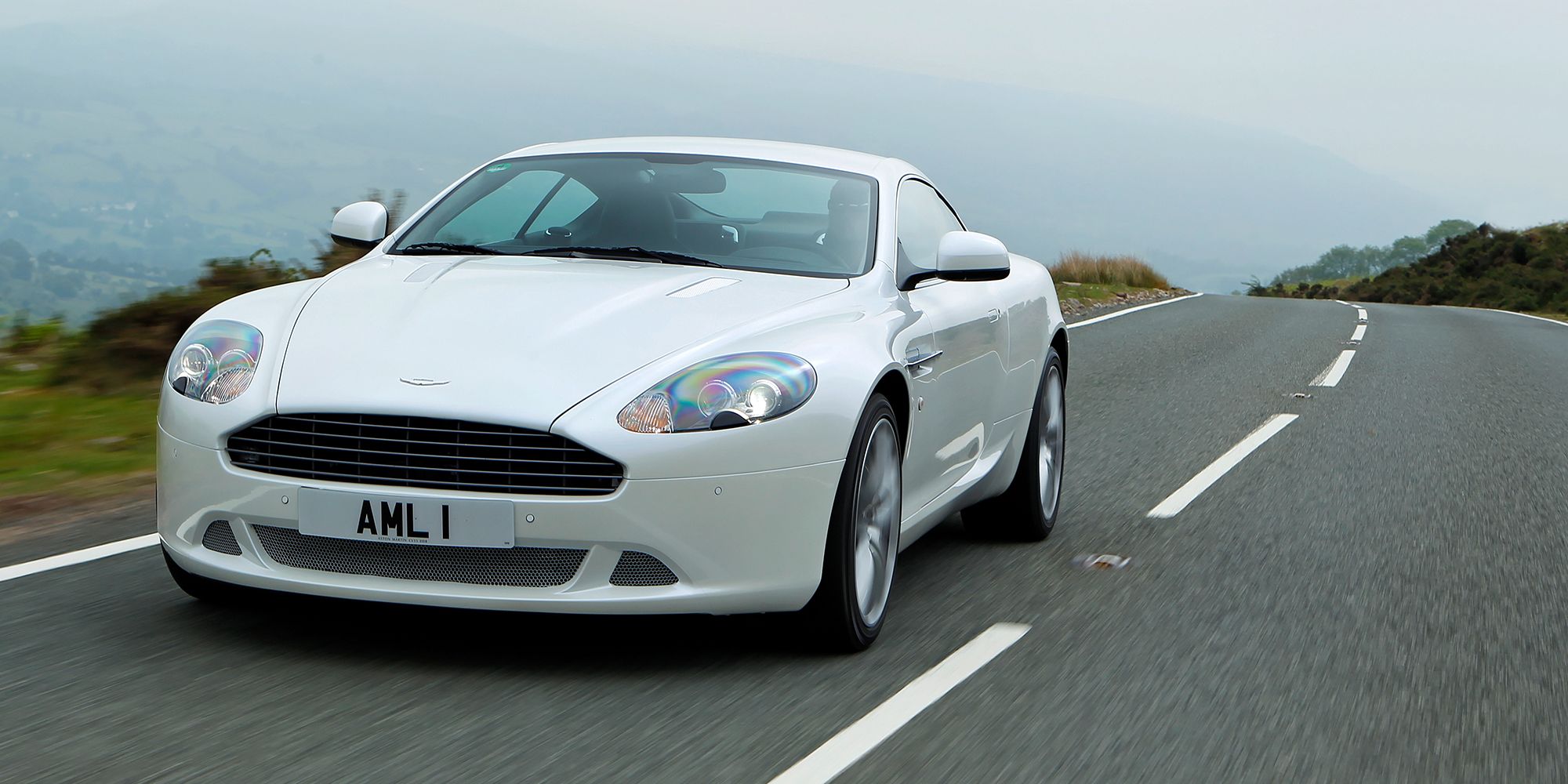 The front of a white DB9 on the move