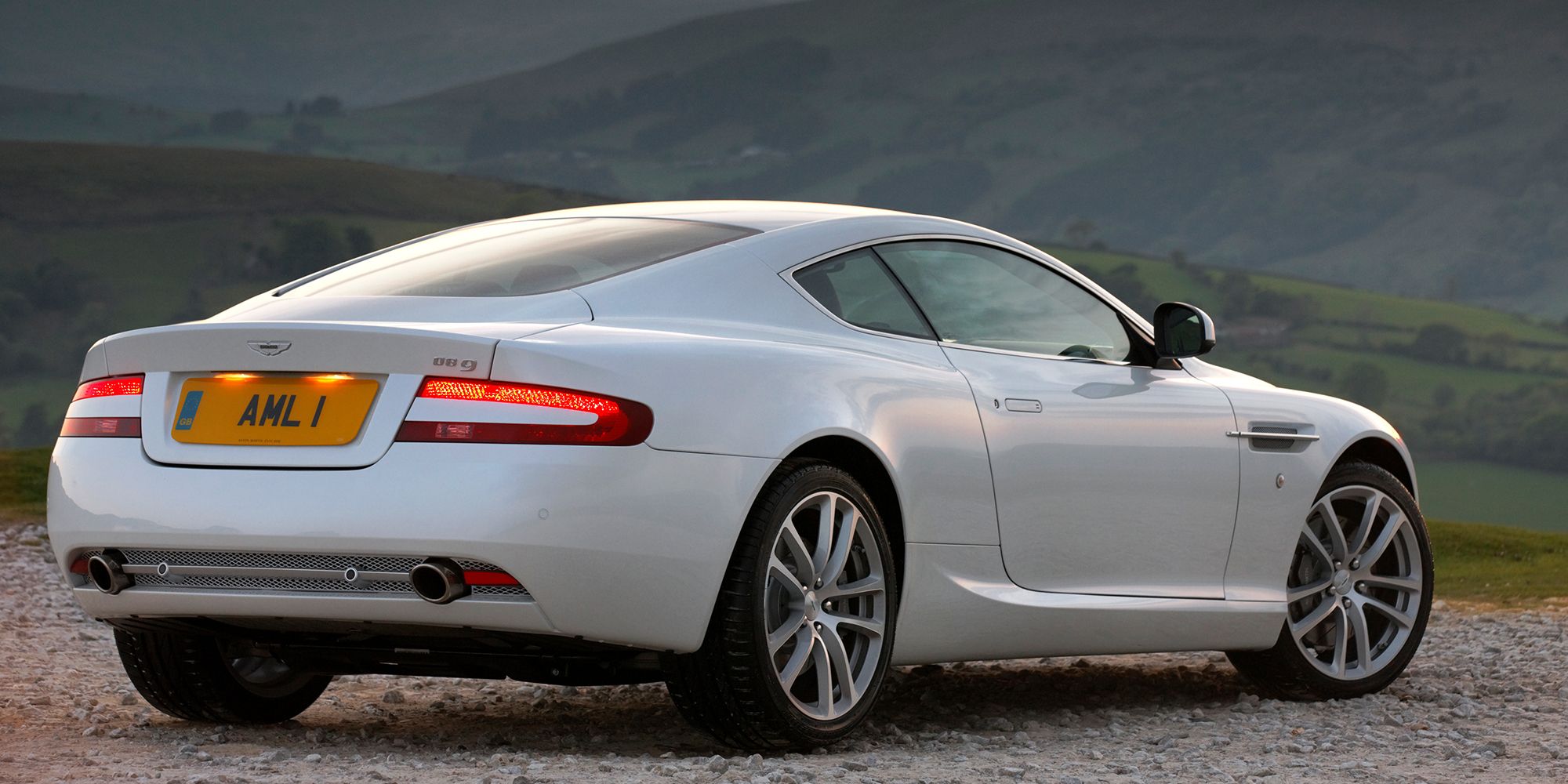 The rear of a white DB9 on the move