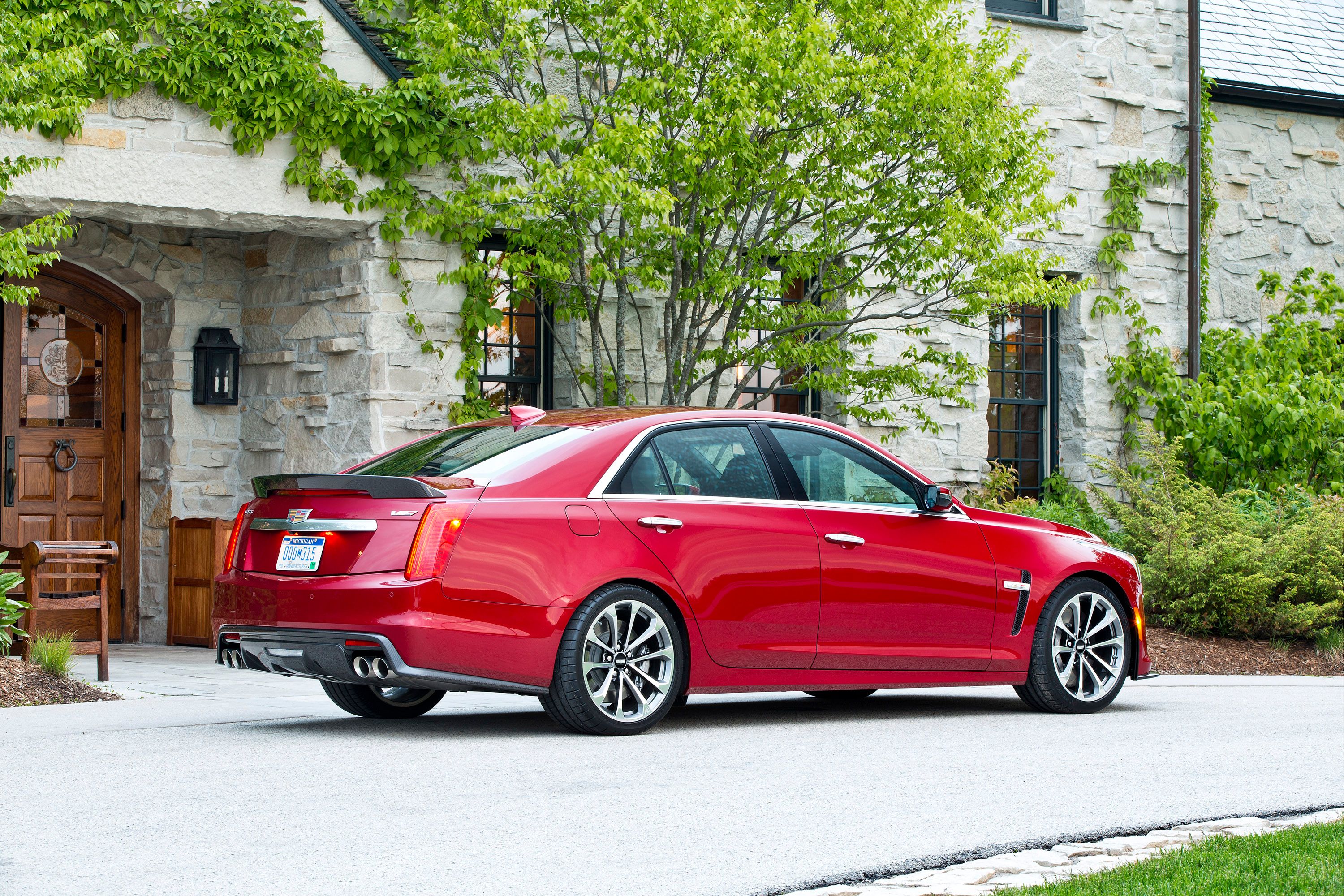 A red Cadillac CTS-V parked.