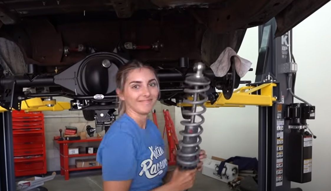 Emilia Hartford installing new shocks and springs on Buick Regal