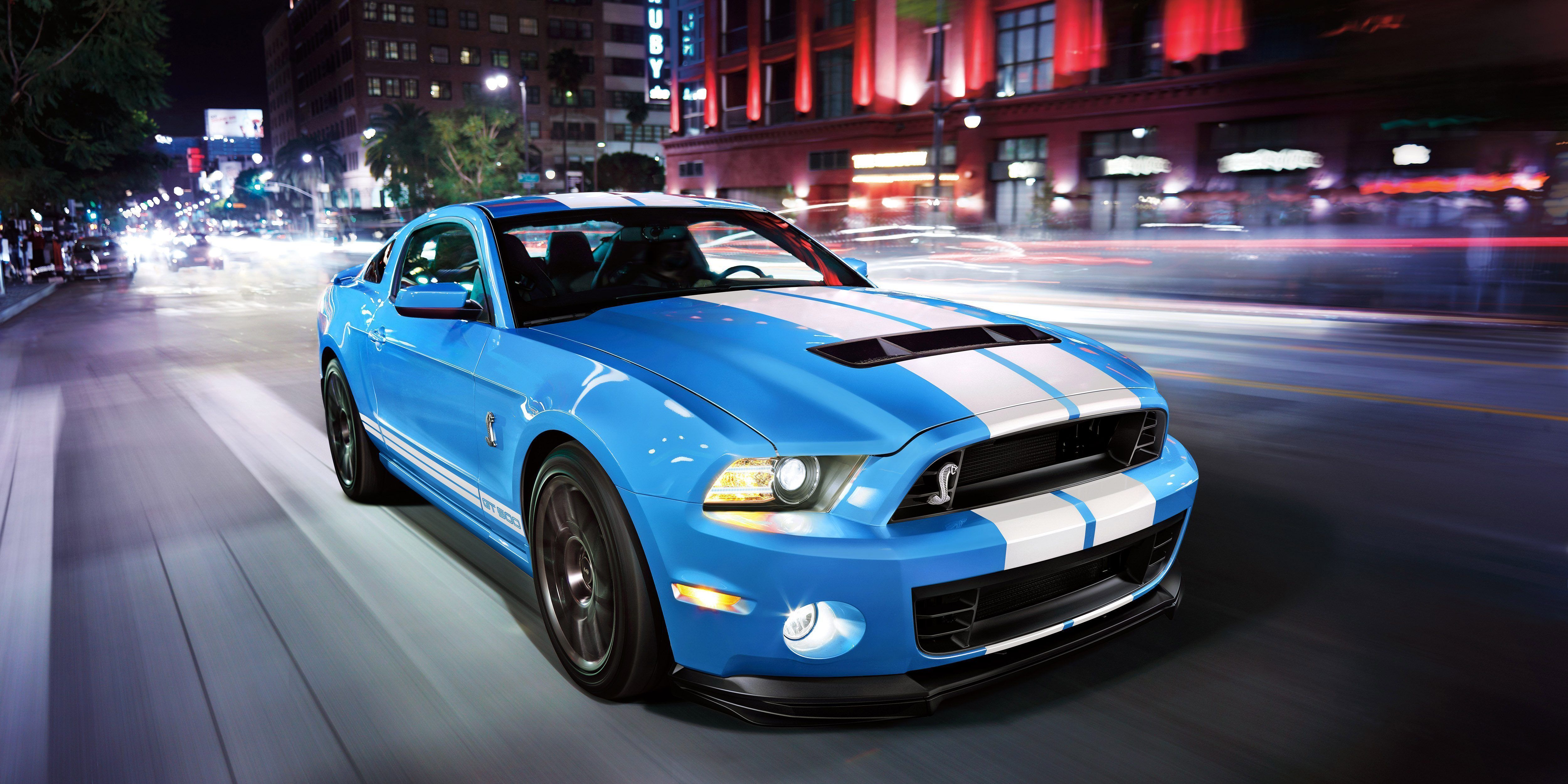 A blue Shelby GT500 on the street.