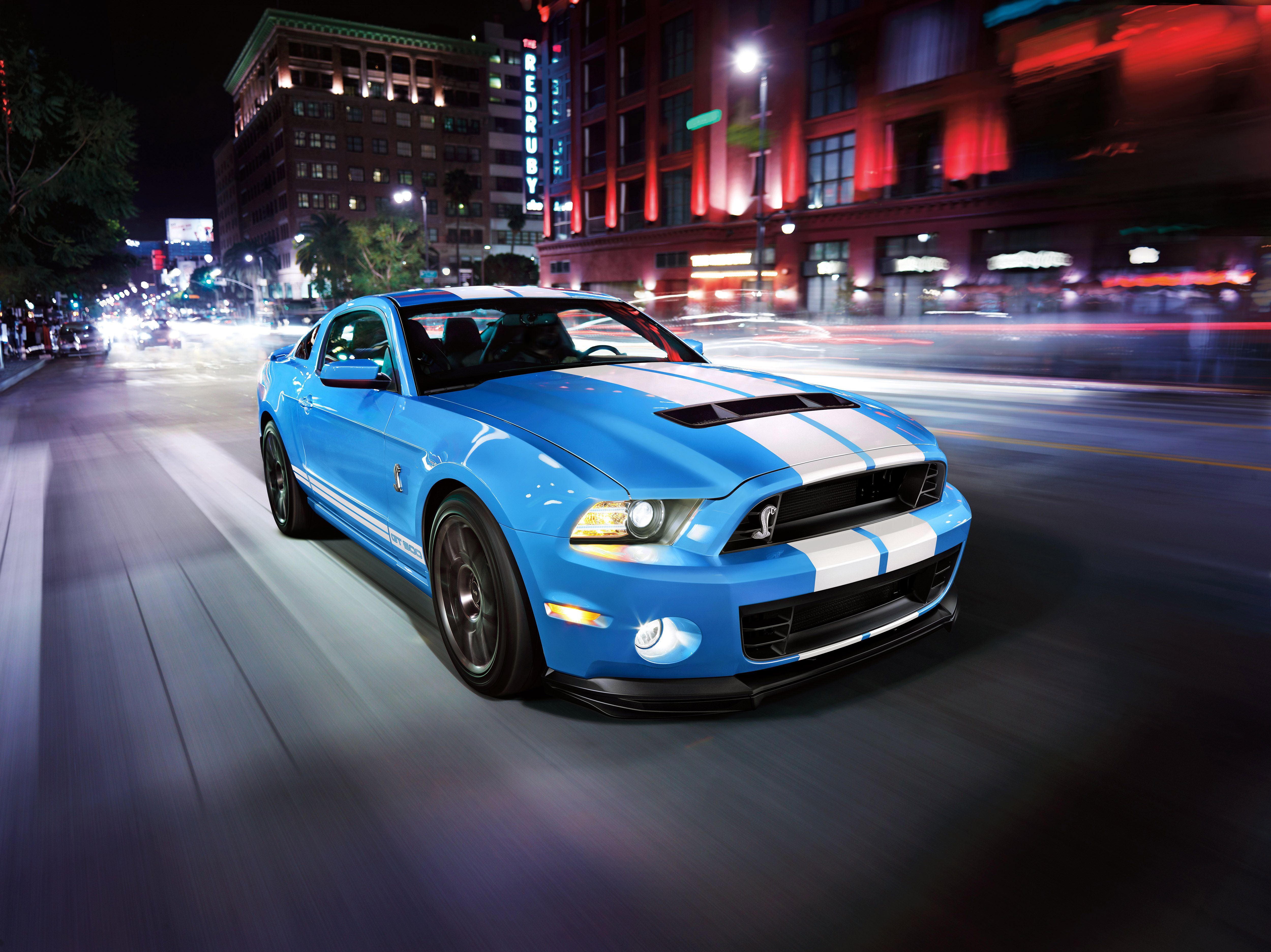 A blue Shelby GT500 on the street.