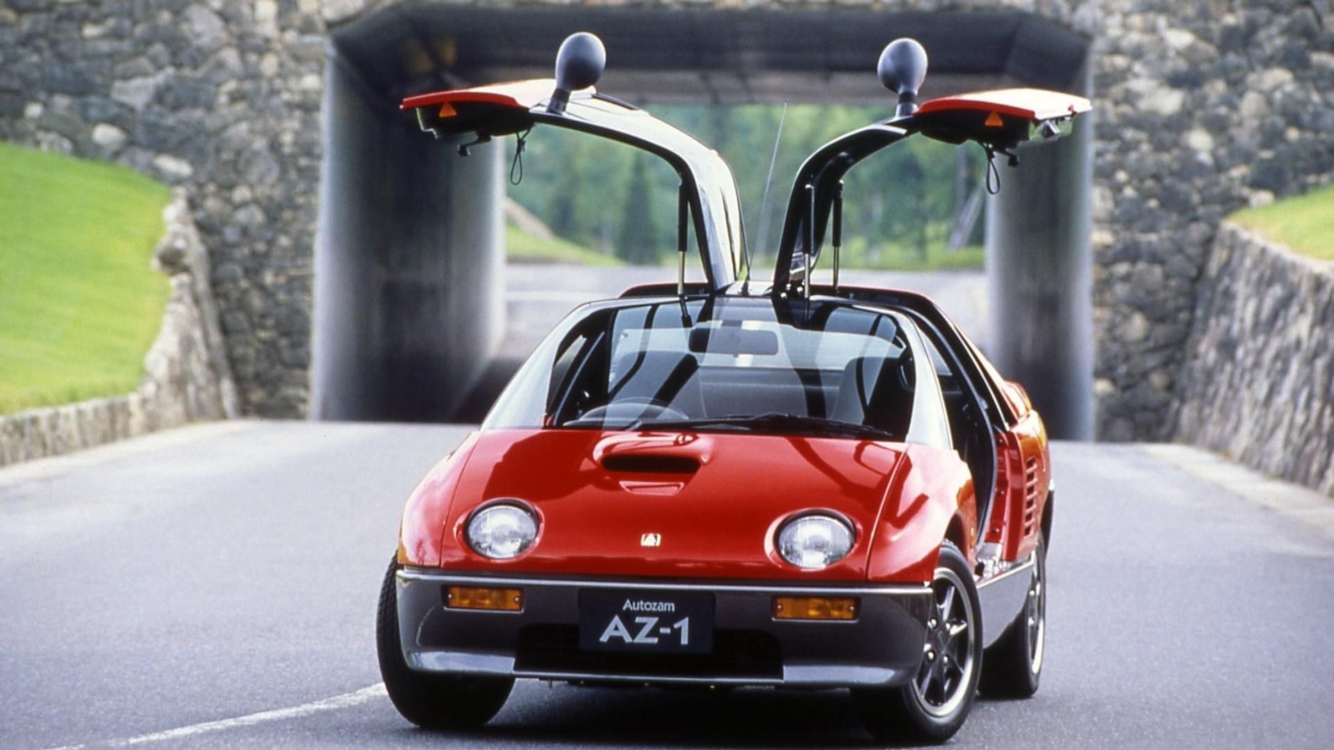 Red Gullwing Door car on road