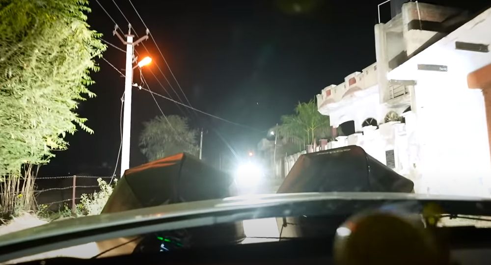 Hyundai with photographer studio lights drives through village