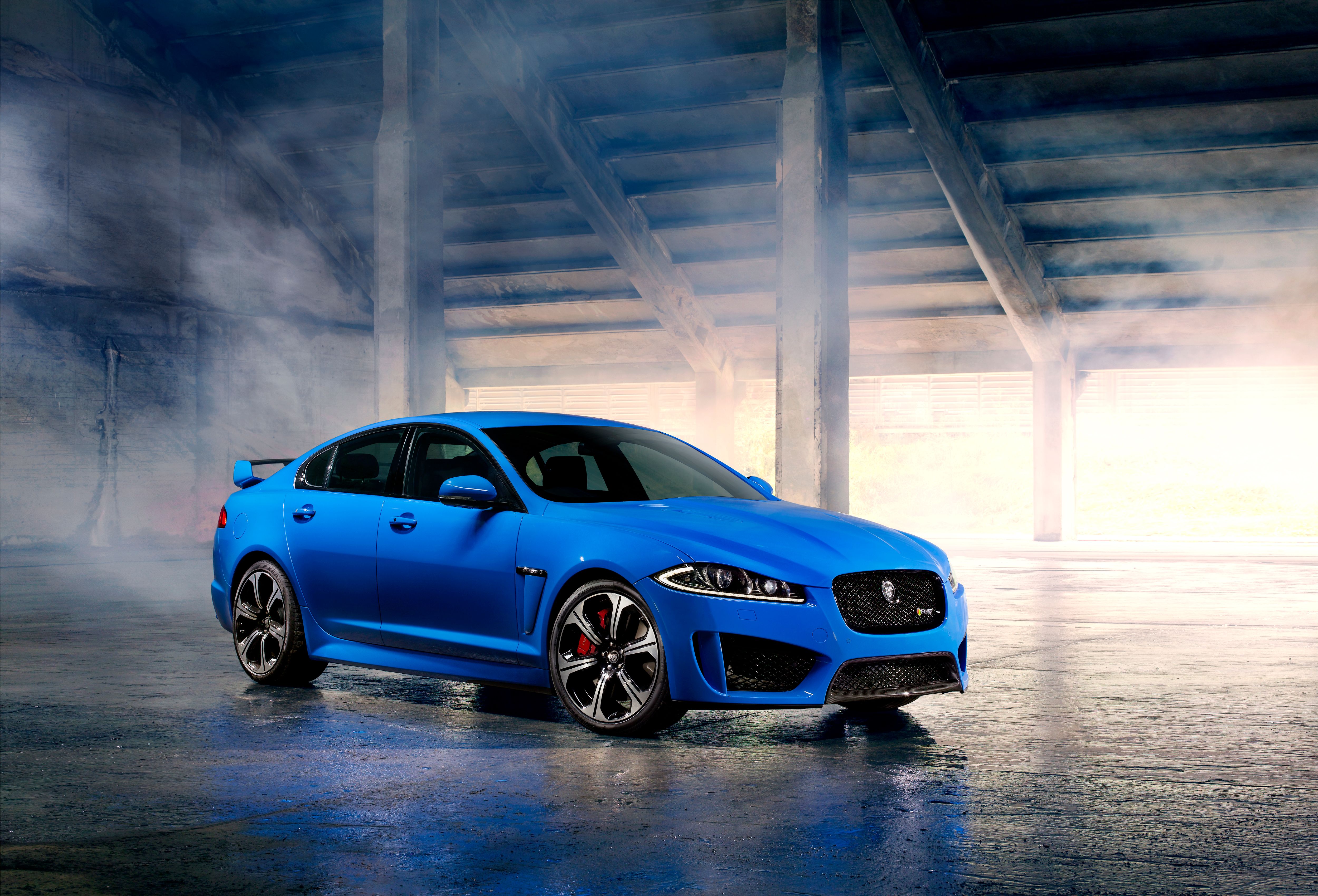A Jaguar XFR-S surrounded by smoke.