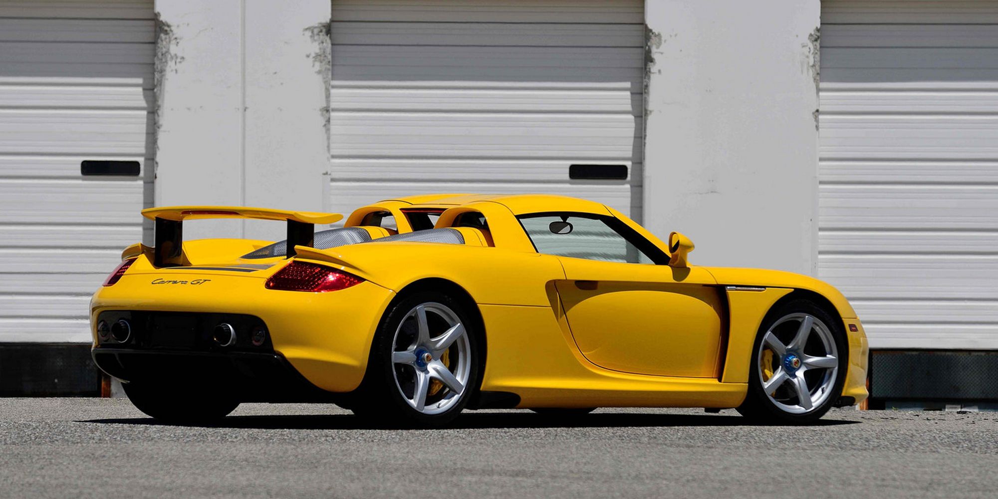 Rear 3/4 view of a yellow Carrera GT