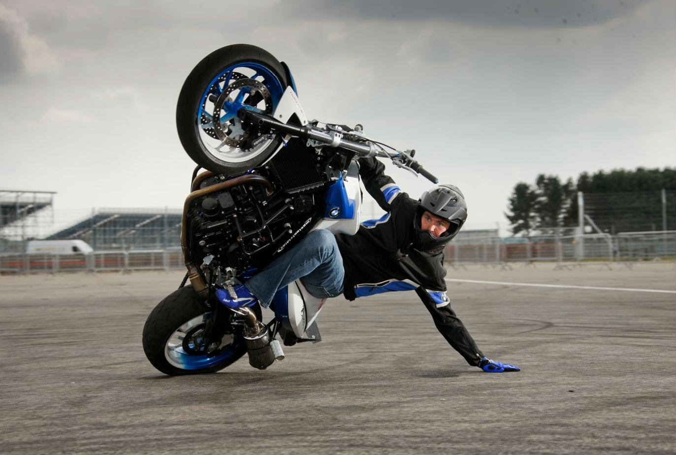 Motorcycle stunt, man doing stationary wheelie
