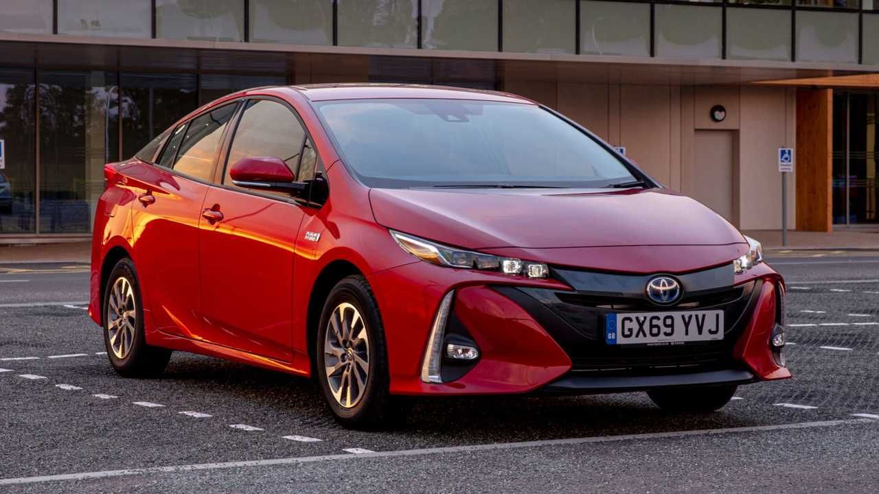 A red 2021 Toyota Prius is on a parking spot.