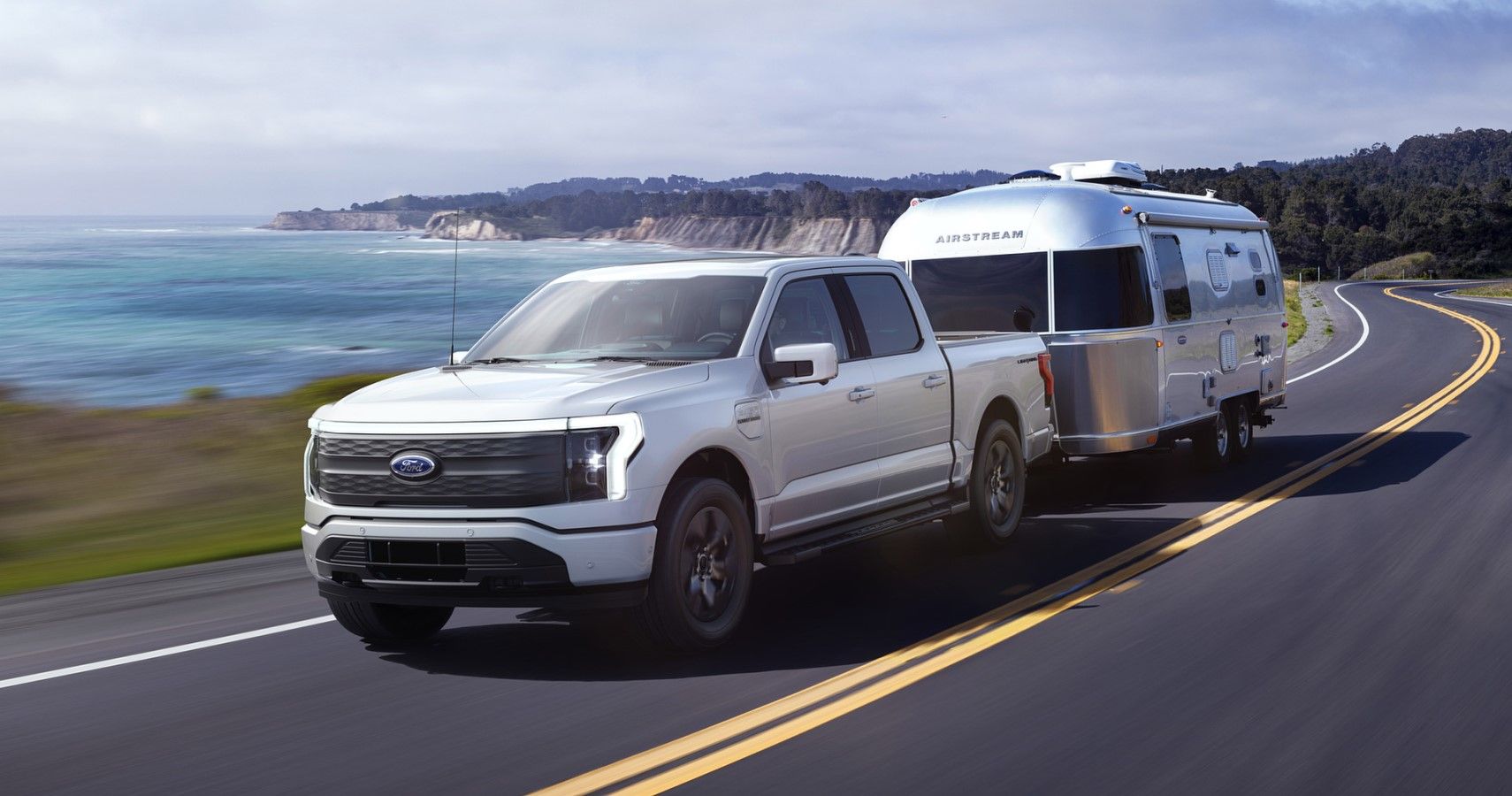 2022 Ford -150 Lightning front third quarter towing view