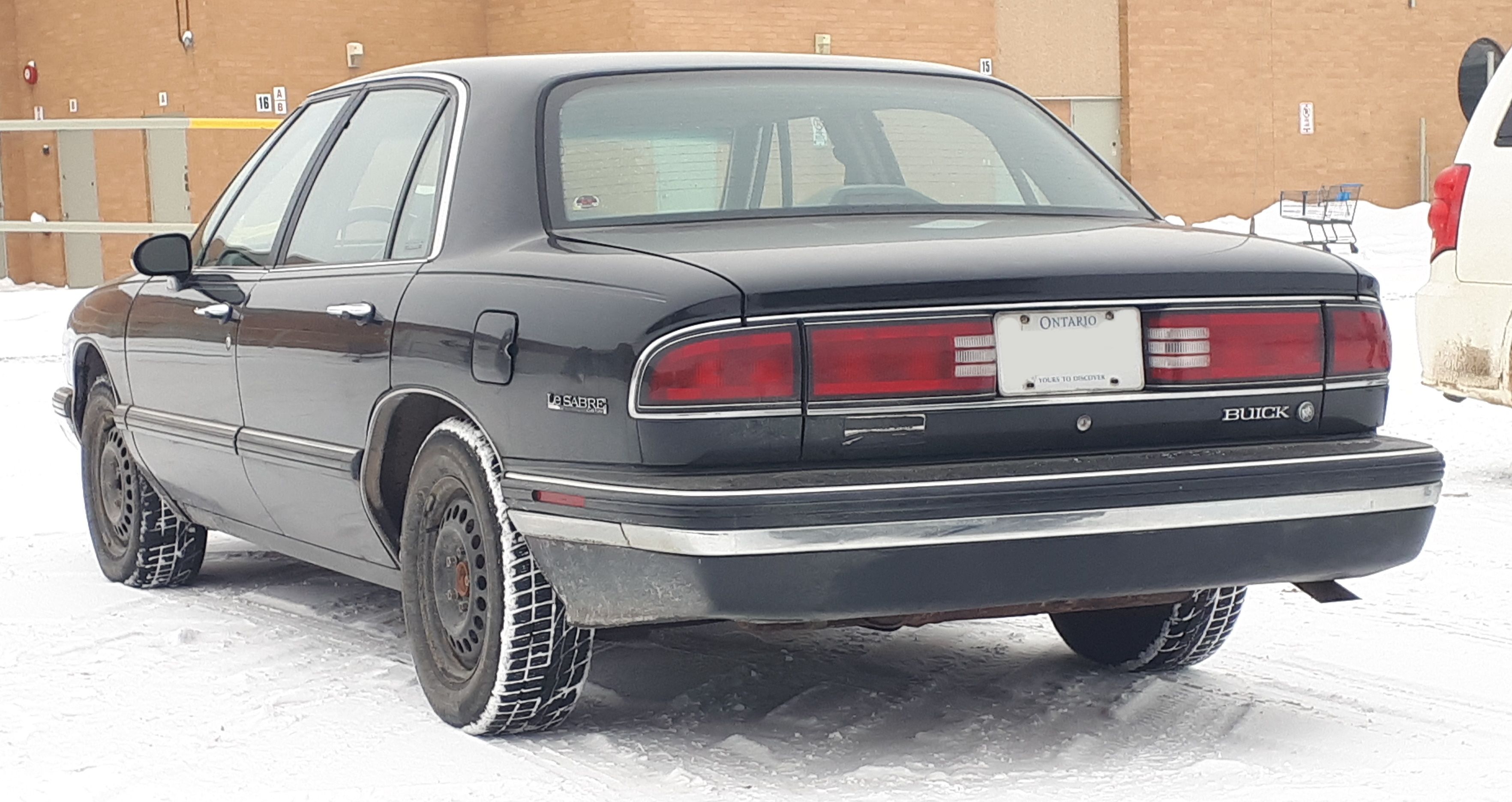 A '90s Buick LeSabre in black.